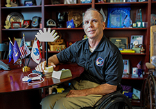 Dr. Rory Cooper, director of the Human Engineering Research Laboratories, displays three of the products being developed through the Technology Transfer Assistance Project (L-R): the heat-enhanced pulse oximeter, the cord caddy, and the prosthetic hook mouse. (Photo by Michael Lain)  