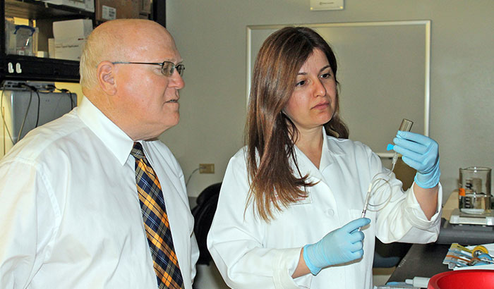 Dr. Alan Frazer, with VA and the University of Texas Health Science Center in San Antonio, looks on as colleague Dr. Flavia Carreno prepares a solution of the ketamine-like compound L-655,708  for a study in rodents. 