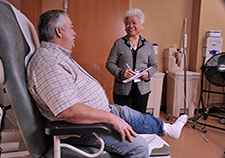 Dr. Elly Budiman-Mak administers the Foot Function Index to Ron Hollingsead, who served in the Marines during the Vietnam War. 