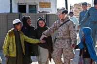 Navy Petty Officer 2nd Class Kimberley Ryan guides Afghan children to a class in Helmand province in January 2012. 