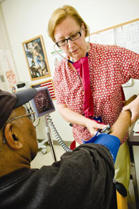 One of the areas addressed by VA's new CREATE research initiative is primary care. Here, Barbara Murphy checks the blood pressure of VA patient Hyslof Jones at the Philadelphia VA Medical Center. (Photo by Tommy Leonardi) 
