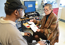 CONFIRM study coordinator Elaine Nevins explains a colorectal cancer screening procedure to Navy Veteran Alex Pryor at the VA Puget Sound Health Care System. 