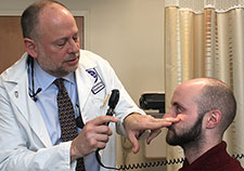  Dr. Mark Schwartz examines Marine Corps Veteran Andrew Serrels at the VA New York Harbor Healthcare System. Schwartz's research focus is diabetes prevention. (Photo by Claudie Benjamin)  