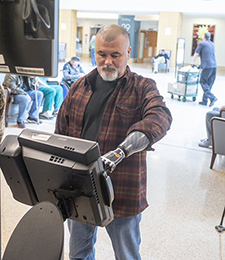 Lewis uses a kiosk in the lobby of the VA Pittsburgh Healthcare System. (Photo by Bill George) 