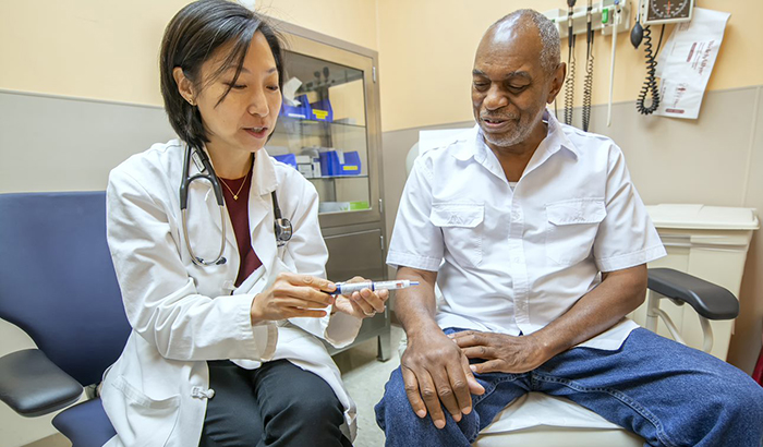 Dr. Mary Rhee, a physician-researcher with the Atlanta VA and Emory University, discusses the use of an insulin pen with VA patient Joseph Fields. (Photo by Lisa Pessin) 