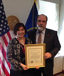 Dr. Robert Jesse, a former VA principal deputy undersecretary for health, presents Rani Elwy with a certificate of appreciation in 2014 for the work she and her team did to improve how VA responds to adverse events.