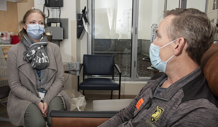 Dr. Julie Graff, an oncologist at the Portland VA, consults with Army Veteran David Atkinson. She's using precision oncology to treat his aggressive prostate cancer. (Photo by D. Michael Moody)