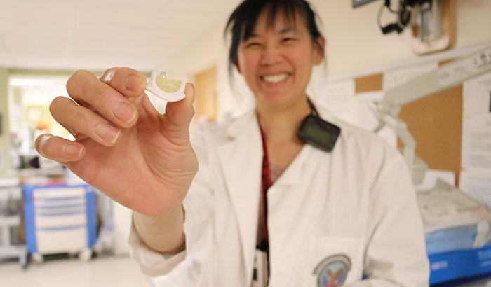 Dr. Jacquelyn Quin, a thoracic surgeon at the VA Boston Healthcare System, displays a model of a bioprosthetic valve. Bioprosthetic valves are made from cow or pig tissue. They are inserted surgically to replace aortic valves that are no longer able to properly control blood flow from the heart out to the rest of the body. (Photo by Mackenzie Adams)