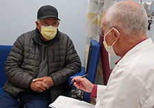 Nuclear medicine physician Dr. Thomas Dresser (right) consults with Air Force Veteran Kenneth Stufflebean. PET images showed that prostate cancer has spread to two lymph nodes in Stufflebean's pelvis. (Photo by Mindy Roettgen)