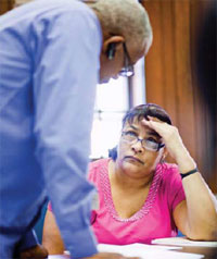 Juanita Chapman, who served in the Army in the 1970s, works with Bobby Nichols of the Greater Los Angeles VA Healthcare System on an application for VA Supportive Housing.