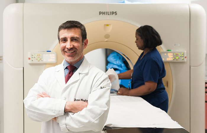 Dr. Drew Moghanaki is a lung cancer specialist who today serves as section chief of radiation oncology at the Atlanta VA Health Care System. In the background is Glenda Campbell, chief radiation therapist at Hunter Holmes McGuire VA Medical Center in Richmond, Virginia. (Photo courtesy of Richmond VA) 