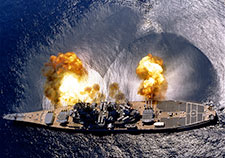 This image dramatically depicts how blasts—in this case, from the big guns of the USS Iowa in an exercise off the coast of Puerto Rico in 1984—create shock waves in the surrounding water. Scientists are working to better understand the role of such shock waves in traumatic brain injury. (PHAN J. Alan Elliott/USN)