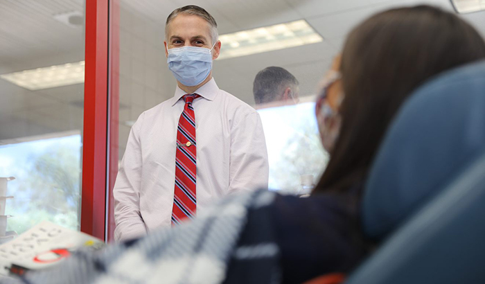 Dr. Jason Dazely, an infectious disease specialist at the Southern Nevada VA, checks in on Dr. Parisa Khan as she prepares to donate her plasma. (Photo courtesy of Southern Nevada VA)