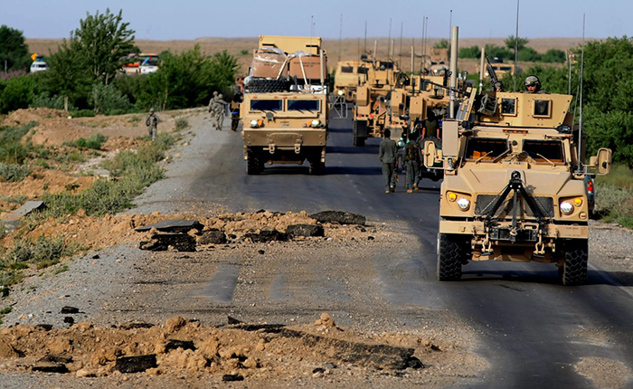 U.S. soldiers make their way around holes created by improvised explosive devices (IEDs) in Afghanistan in 2010. Understanding the long-term effects of blast injuries on the brain has been a priority for VA research. (Photo by Senior Airman Kenny Holston/USAF)  