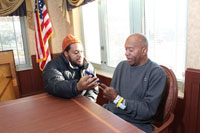 Leon Bryant spends time with his father, Leon Douglas Bryant, at the VA community living center in Baltimore where the elder Bryant now lives. (Photo by Mitch Mirkin)   