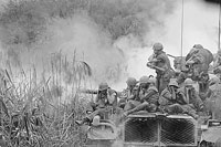 Tracking brain outcomes for Vietnam Vets-Marines riding atop an M-48 tank cover their ears as a 90mm gun fires during a road sweep in Vietnam. A VA-led study is exploring whether Vietnam Veterans who experienced traumatic brain injury or posttraumatic stress disorder are more likely to develop dementia as they age. (Photo: National Archives)  