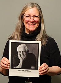 Amy Binns-Calvey holds a photo of her late father, James 