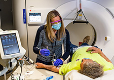 Medical imaging supervisor Christine Thalheimer assists Vietnam Veteran Mr. Bobby Richardson during his CT scan. (Photo by Mark Turney, Richard L. Roudebush VA Medical Center.)