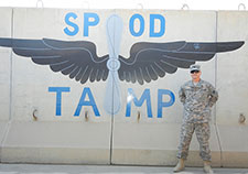 Rob Masevicius stands in front of a steel-reinforced concrete blast wall at a Theater Aviation Maintenance Program facility at a seaport of debarkation in Kuwait in 2010. 