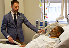 Dr. Matthew Tuck checks in with patient Willie White, a Vietnam-era Air Force Veteran who is enrolled in the ACCOuNT study. <em>(Photo by Mike Richman) </em>