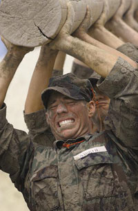 A team of Navy Seal lifting a heavy log