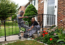 Burgess and Wilkens enjoy the outdoors on the front porch of her suburban Baltimore townhouse. (Photo by Robert Turtil)