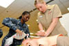 U.S. Navy Lt. j.g. Shantel Morris, left, and Ensign Kirsten Lepp, assigned to the Naval Medical Center in San Diego, practice CPR on a mannequin during a cardiac life support course. VA researchers have reported new findings on the link between mental and physical health problems in women Veterans