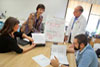 Veteran Lonny Ellison (right) works with an occupational therapy team as part of a special cognitive training program at the San Francisco VA Medical Center. VA research has determined that for many Veterans, effectively treating PTSD and depression may help greatly in restoring cognitive function following TBI. 