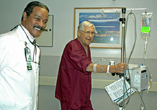 Recreation aide Ural Kincaid walks with Veteran Wyatt Brinkley on a VA inpatient unit as part of the STRIDE Program.  