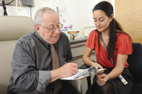 VA's Million Veteran Program recently enrolled its 100,000th Veteran. Here, at an earlier stage of the study, Dr. Pantel Vokonas (left) enrolls in the study at the VA Boston Healthcare System with research assistant Shelley Amberg. Vokonas, a cardiologist for VA, served with the U.S. Navy Medical Corps in Vietnam.