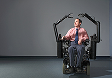 Dr. Rory Cooper demonstrates a robotic arm developed at the Human Engineering Research Laboratories, which he directs.<em> (Photo courtesy of HERL)</em> 