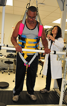 Veteran Patrick Adams, seen here with Dr. Mon S. Bryant, took part in a study on multidirectional treadmill training. (Photo by Shawn James)</em>