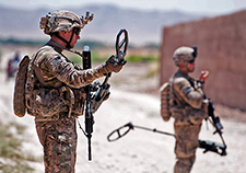 Troops with the 82<sup>nd</sup> Airborne Division prepare to sweep a road for improvised explosive devices in Afghanistan's Ghazni province in 2012. IEDs have been a common cause of blast injuries in U.S. troops in Iraq and Afghanistan. <em>(US Army photo)</em> 