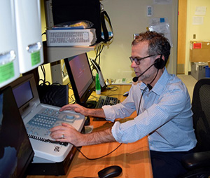 VA Portland research audiologist Dan McDermott tests the AudioStar audiometer, a device used to measure hearing acuity.  (Photo by Stephanie Edmunds, VA Portland Healthcare System.)
		