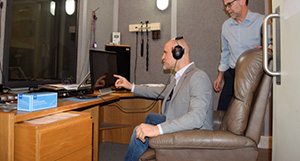 Research coordinator Cody Goheen and audiologist Dan McDermott demonstrate audiometry administration and data collection at the VA Portland Healthcare System. (Photo by Stephanie Edmunds, VA Portland Healthcare System.)
