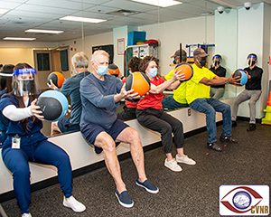 Exercise physiologists with the VA Center for Visual and Neurocognitive Rehabilitation, Kevin Mammino and Cydney Goodwin-Hamel, lead participants in a strength and conditioning program to help keep elderly veterans active and improve their physical fitness.
